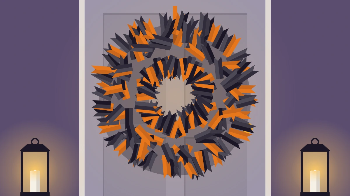 Full, fluffy wreath of knotted black and orange ribbon strips hanging on a gray door