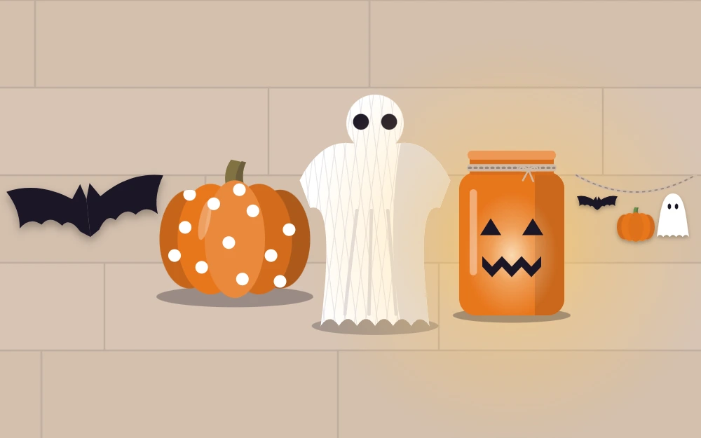 Five starter projects on a craft table: paper bat, painted pumpkin, cheesecloth ghost, jar lantern and felt garland
