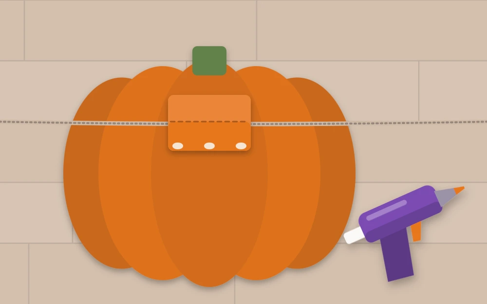 The back of a felt pumpkin with a folded felt tab glued over a length of twine