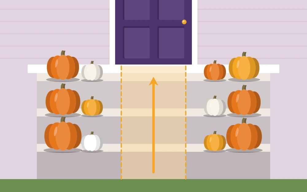 Porch steps with pumpkins grouped at the outer edges and a clear path up the middle