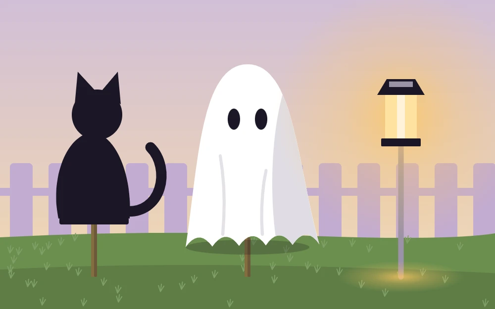 A black cat silhouette, a fabric ghost and a solar stake light on garden stakes