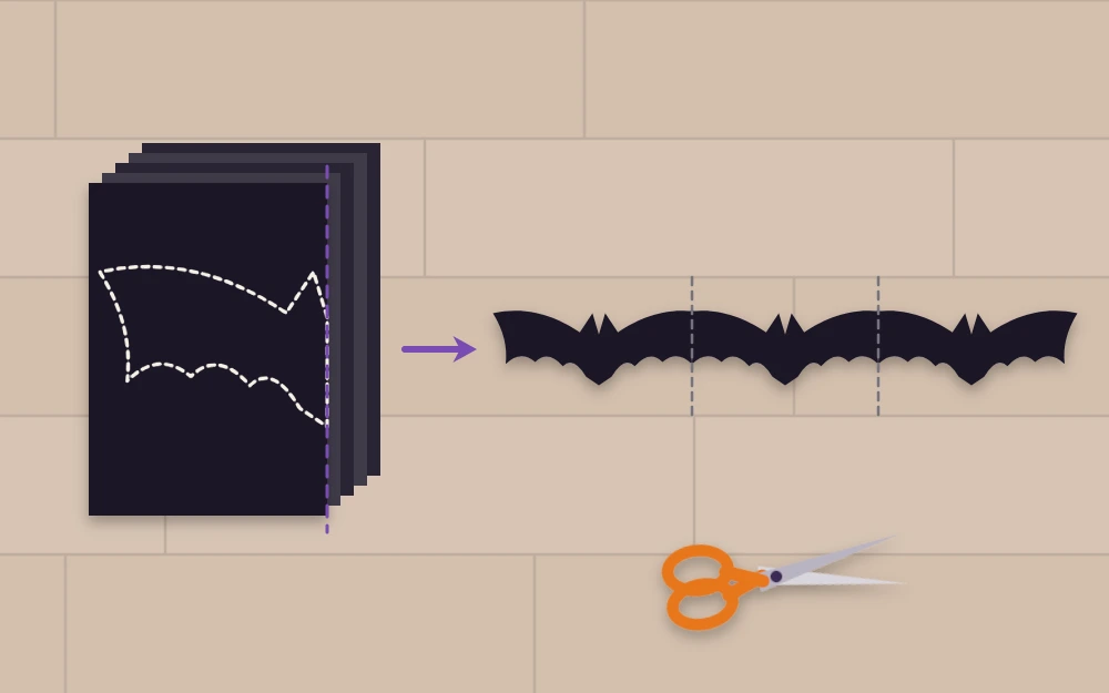 Accordion-folded black paper with half a bat drawn beside the unfolded chain of bats